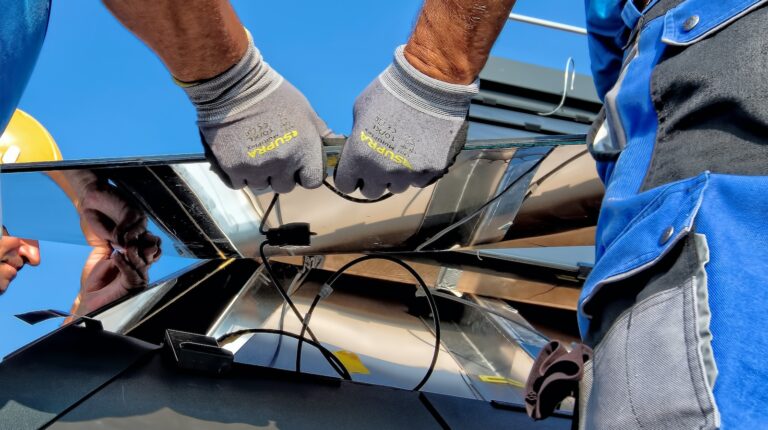 two men carrying a solar panel